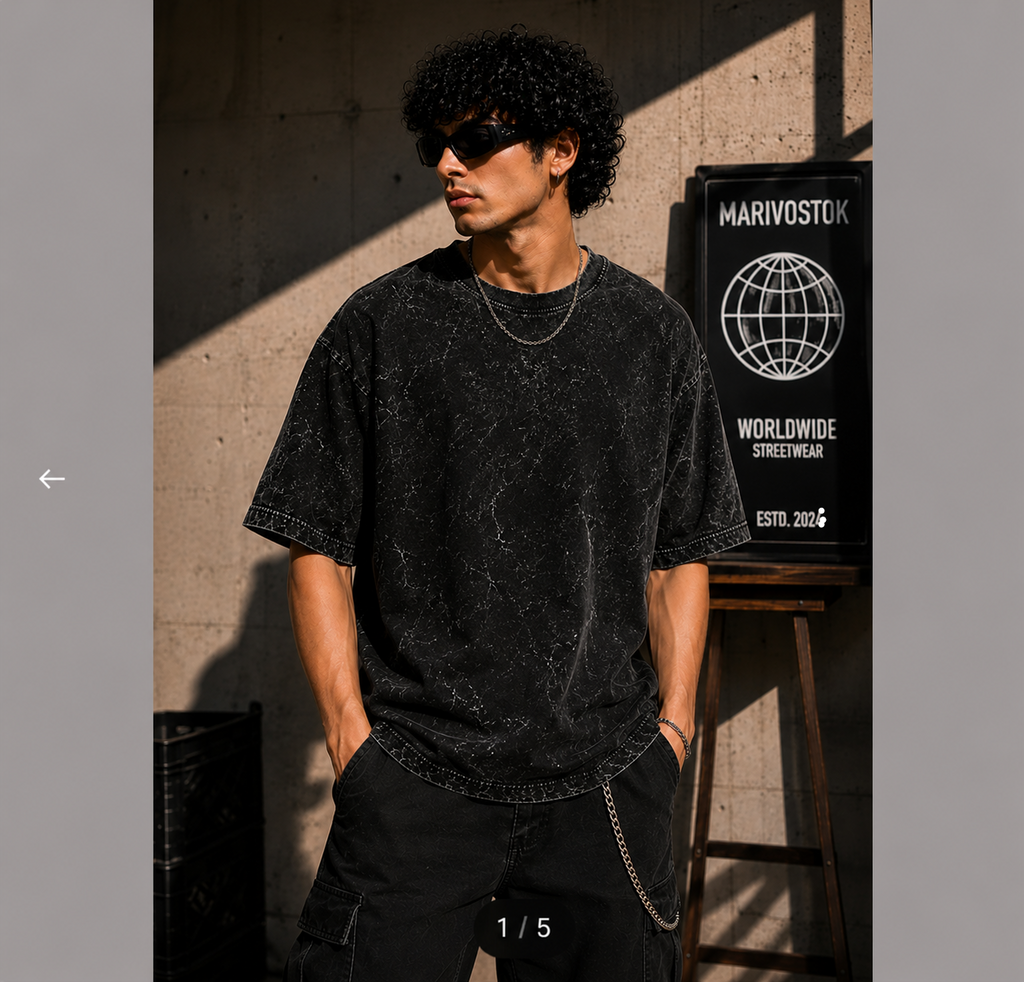 Man wearing a black distressed t-shirt and sunglasses against a textured wall with 'Marivostock' branding.