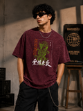 Person wearing a maroon t-shirt with graphic design and text, standing in a casual setting.