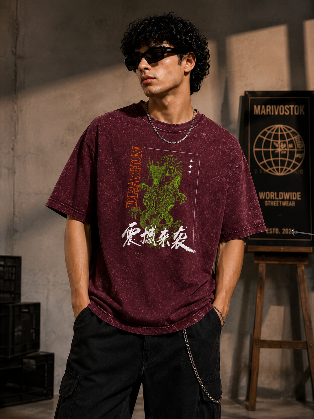 Person wearing a maroon t-shirt with graphic design and text, standing in a casual setting.
