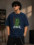 Man wearing a navy blue t-shirt with a dragon graphic and text, standing against a gray wall.