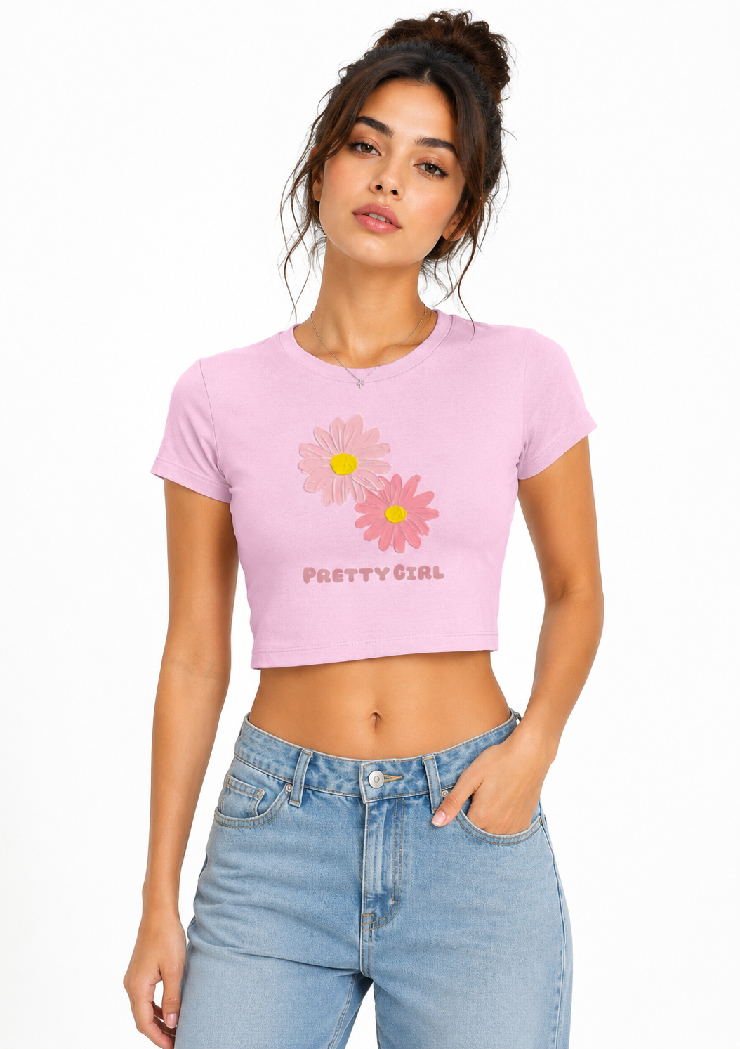 Woman wearing a pink crop top with floral design and text, standing against a white background